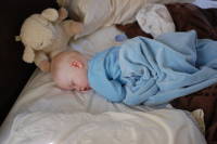 dsc_7694.jpg Sleeping in on his parents' bed.