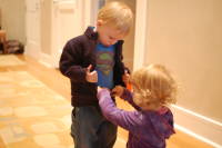 dsc_7671.jpg Edel (we met her mom on a volleyball trip) helps Devin with his sweater.  He doesn't hold still like this when mom & dad dress him!