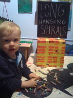 img_0137.jpg At the Children's Museum of Art.  Devin liked pouring out the crayons and putting them back in their tray more than drawing with them.